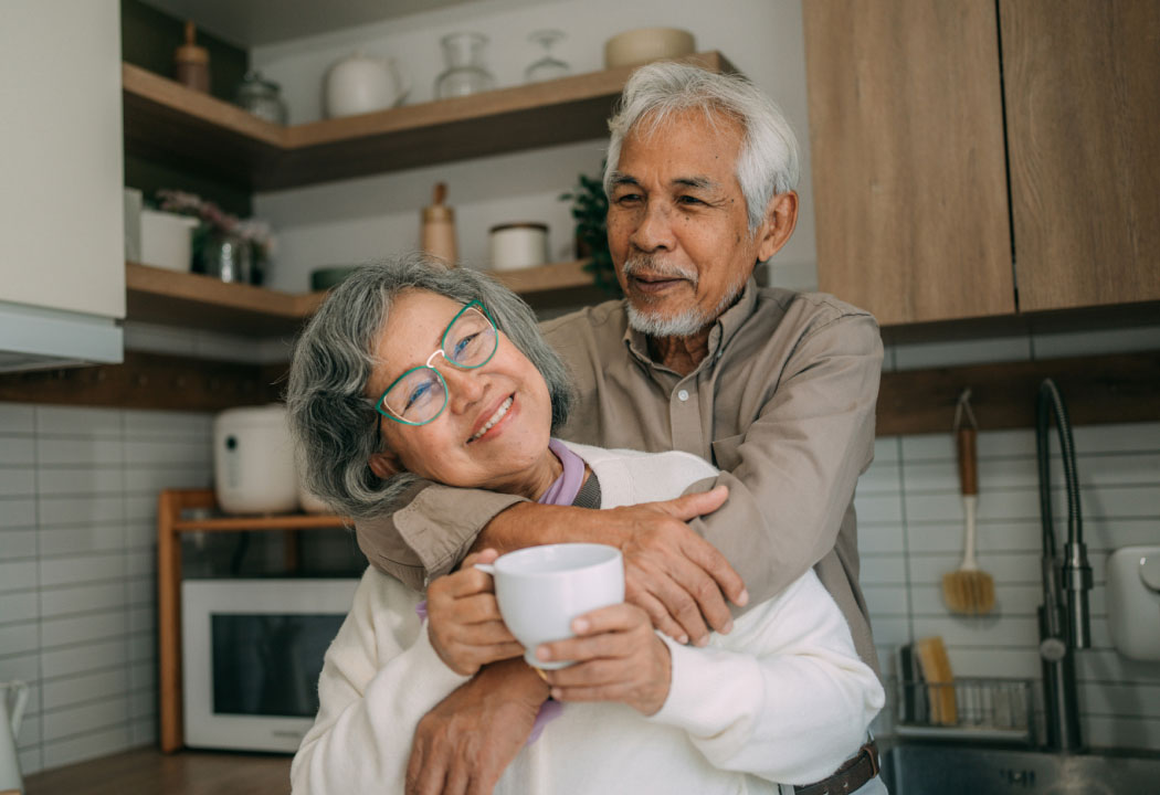 Mature couple hugging in a modern kitchen
