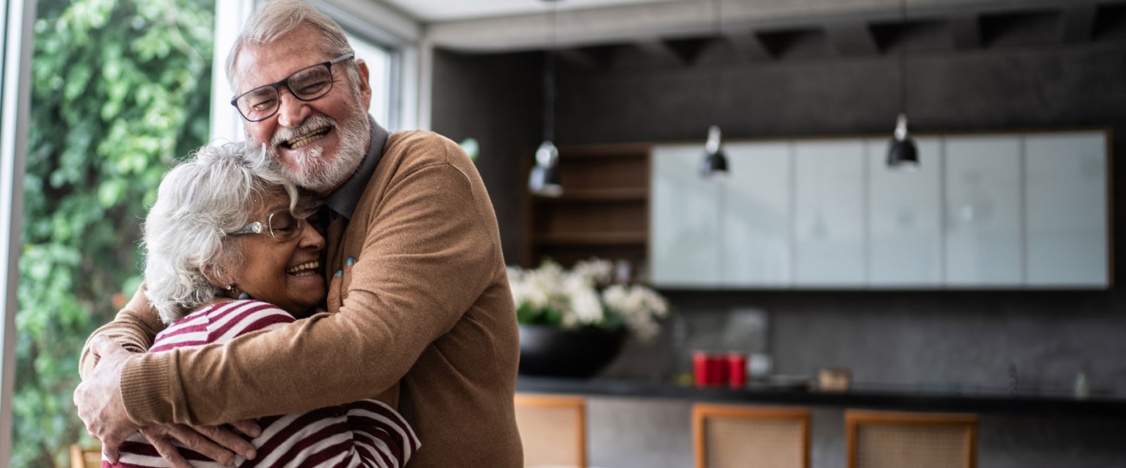 Mature couple hugging in a modern kitchen